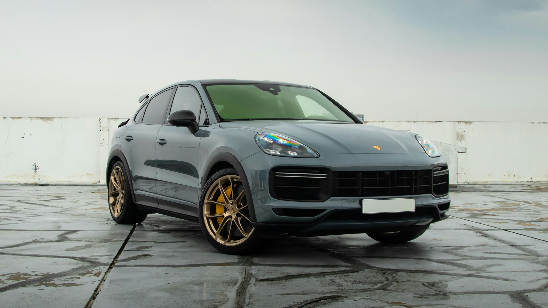Before: grey Porsche Cayenne photographed on an outdoor parking deck